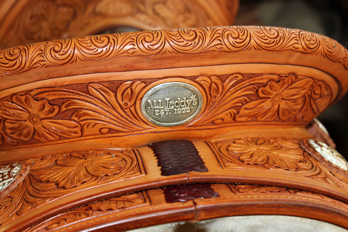 The M.L. Leddy's Est. 1922 medallion set into hand-tooled saddle leather